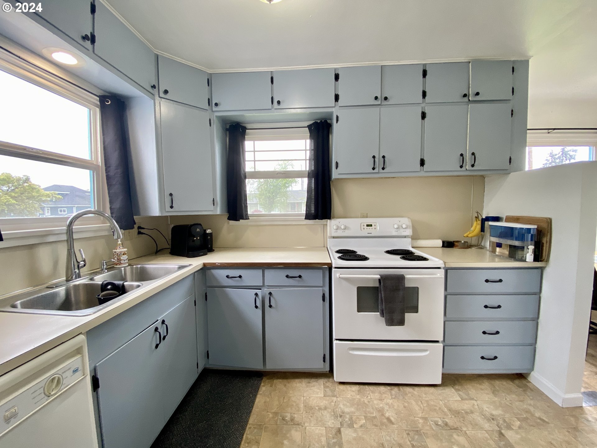 2425 E Street Springfield, OR 97477 - Photo 19 of 36 a kitchen with a stove sink and cabinets