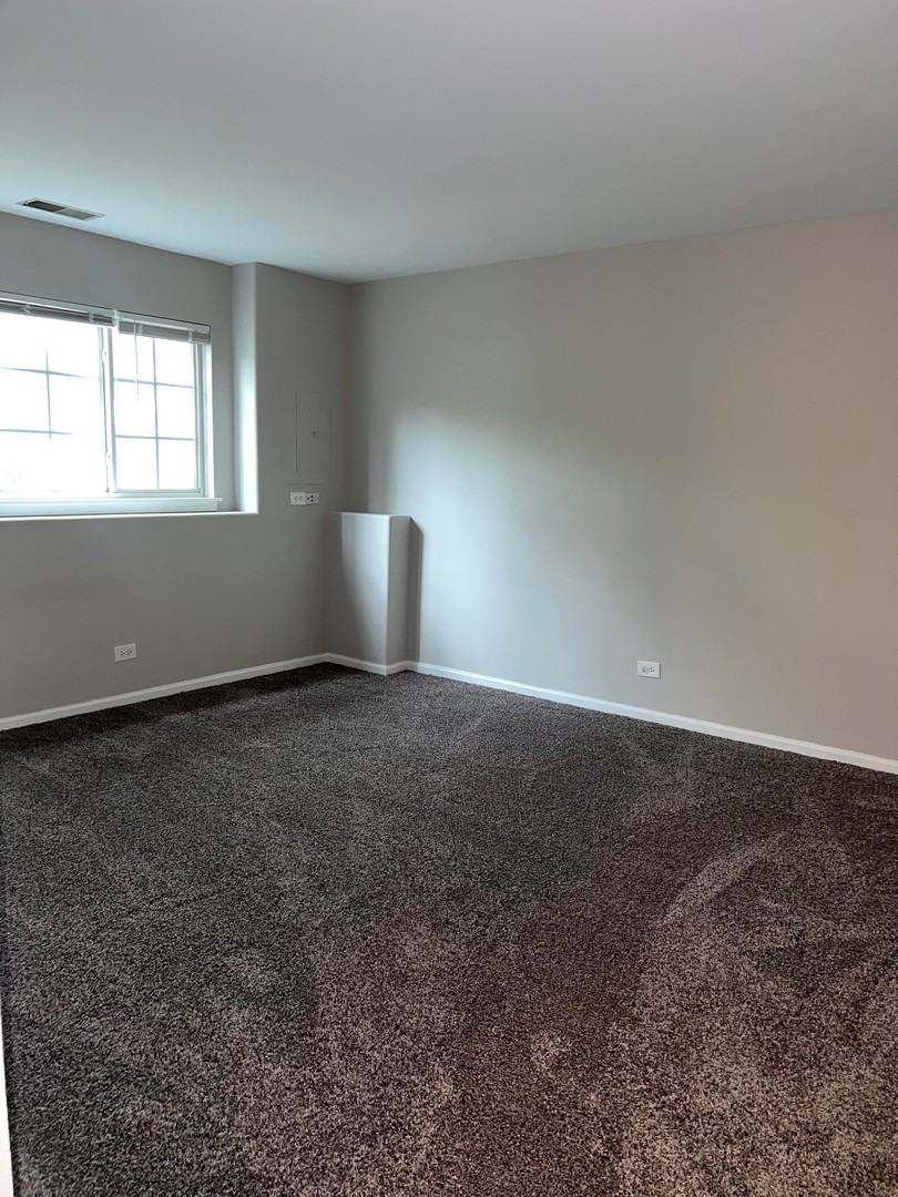 3393 Ravinia Circle Aurora, IL 60504 - Photo 13 of 14 a view of an empty room with a window