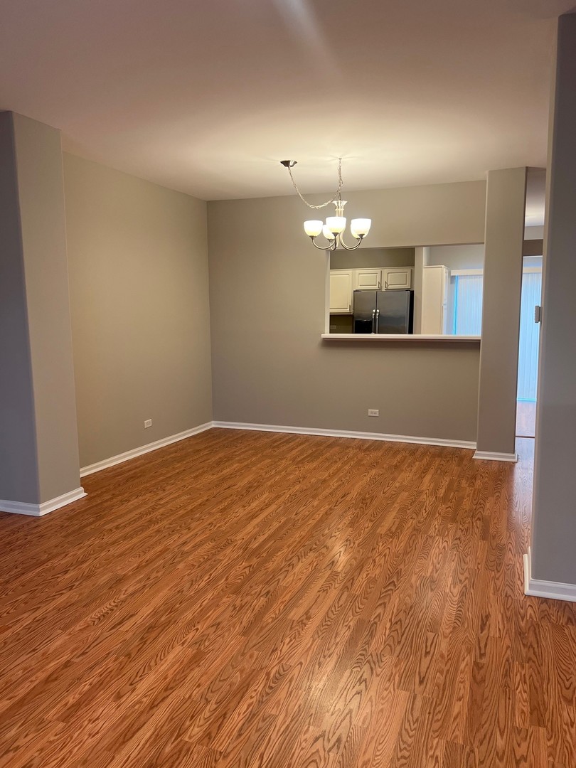 3393 Ravinia Circle Aurora, IL 60504 - Photo 3 of 14 a view of a room with wooden floor