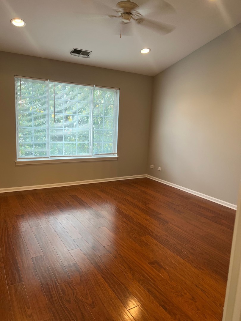 3393 Ravinia Circle Aurora, IL 60504 - Photo 9 of 14 an empty room with wooden floor and windows