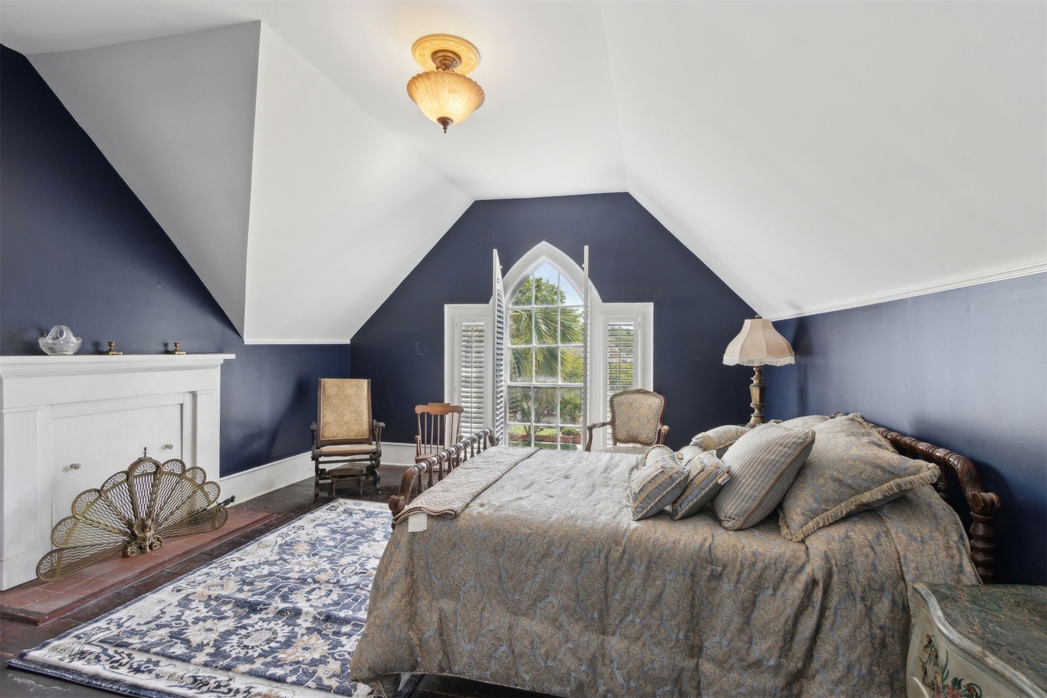 327 South 7th Street Fernandina Beach, FL 32034 - Photo 48 of 71 a bedroom with a bed and a chandelier