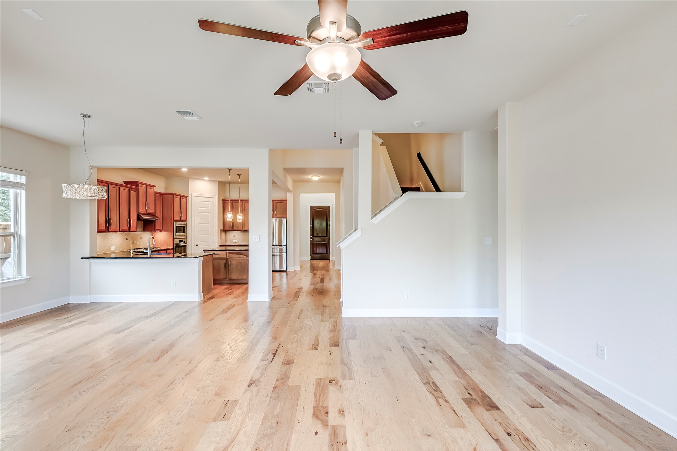 345 Fort Cobb Way Georgetown, TX 78628 - Photo 15 of 38 Gleaming hardwood floors flow throughout the open concept main level with seamless kitchen access.