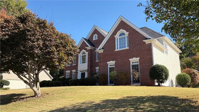 a front view of a house with a yard
