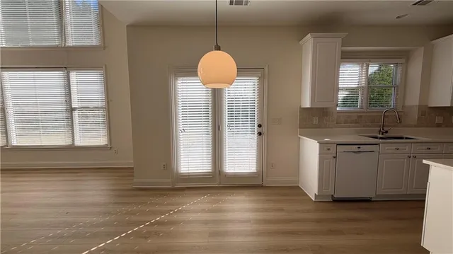 a kitchen with a refrigerator sink and cabinets