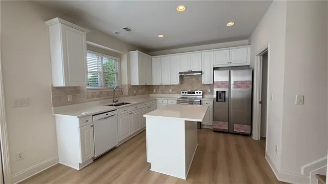 a view of an entryway with wooden floor