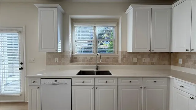 a view of staircase with white walls and a window