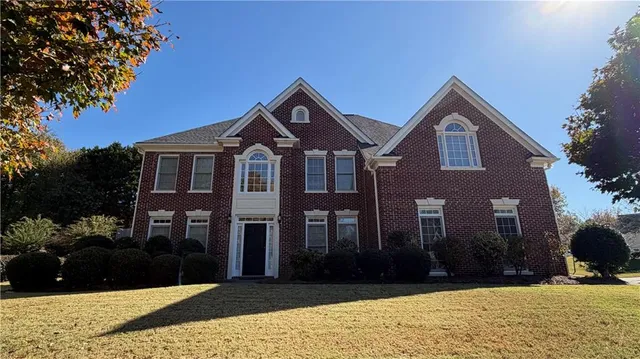 a front view of a house with a yard
