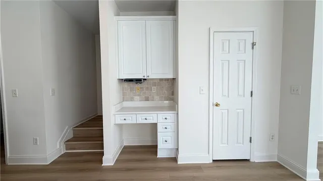 a view of entryway with wooden floor and stairs