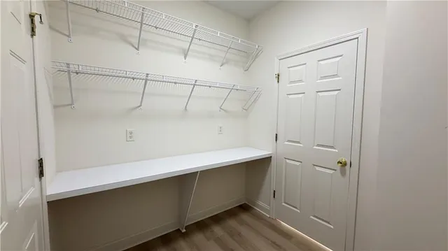 a view of room with wooden floor and window