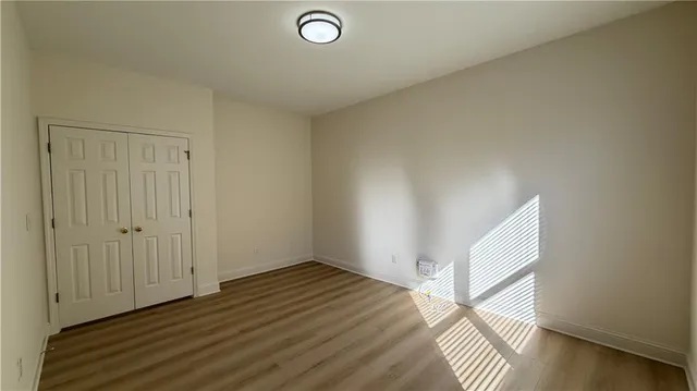 a spacious bathroom with a double vanity sink a large mirror and shower