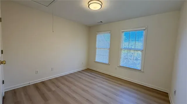 a view of walk in closet with wooden floor