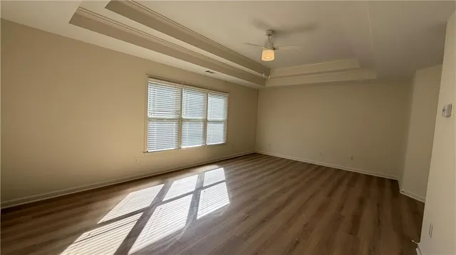 a view of a room with window and hardwood floor