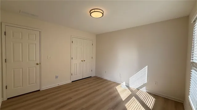 a front view of a house with a yard covered in snow