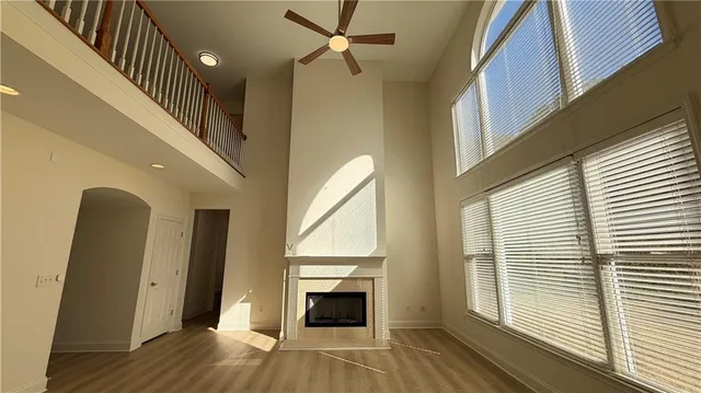 a view of an empty room with a fireplace and a window