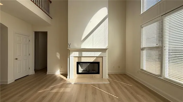 a view of a livingroom with a fireplace and wooden floor