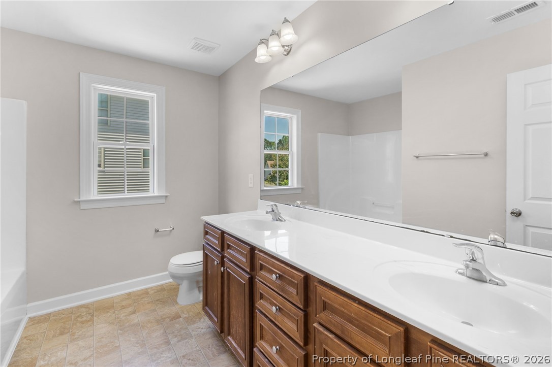 50 Huzzas Circle Cameron, NC 28326 - Photo 27 of 39 a bathroom with a sink a vanity and a large mirror