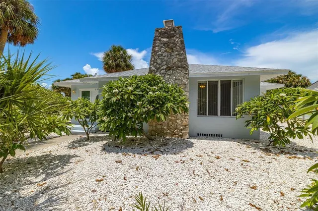 an empty room with windows and fireplace