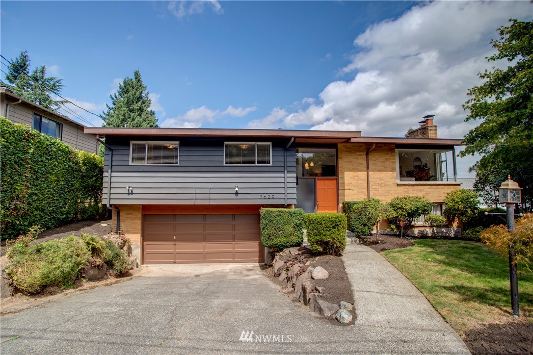 7620 South 115th Street Seattle, WA 98178 - Photo 1 of 33 a front view of a house with a yard and a garage