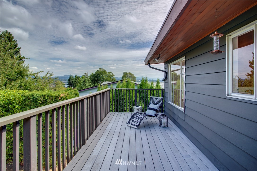 7620 South 115th Street Seattle, WA 98178 - Photo 13 of 33 a view of a balcony with chairs and wooden floor