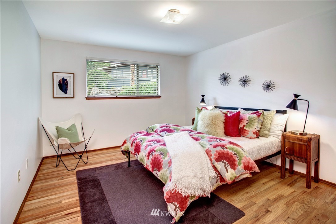 7620 South 115th Street Seattle, WA 98178 - Photo 14 of 33 a bedroom with a bed and wooden floor