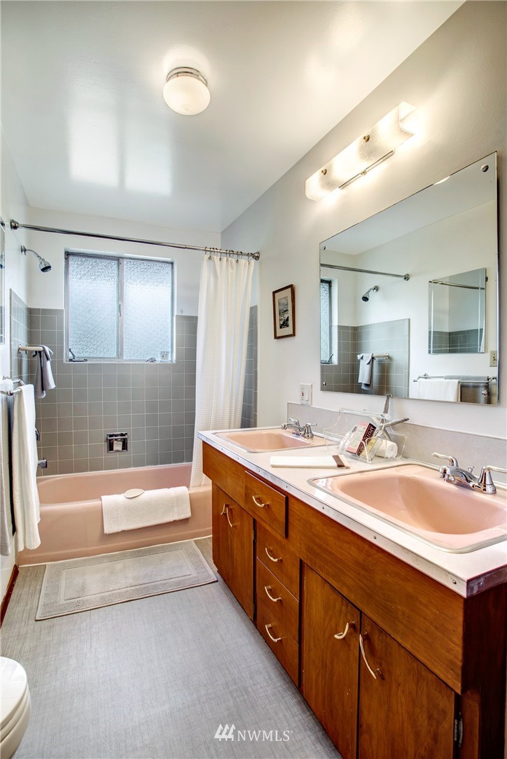 7620 South 115th Street Seattle, WA 98178 - Photo 15 of 33 a spacious bathroom with a tub double sink and a mirror