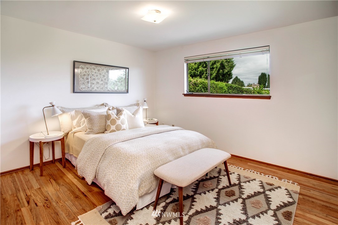 7620 South 115th Street Seattle, WA 98178 - Photo 18 of 33 a bedroom with bed and wall painting