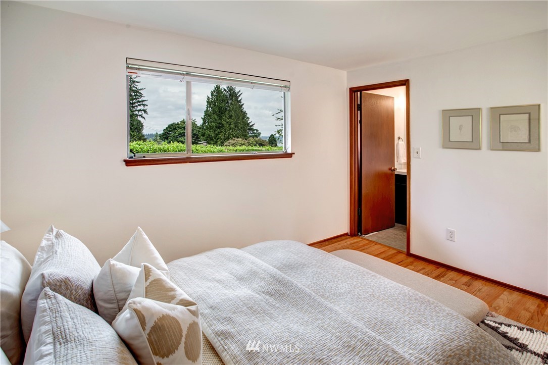 7620 South 115th Street Seattle, WA 98178 - Photo 19 of 33 a bedroom with a bed and a painting on the wall
