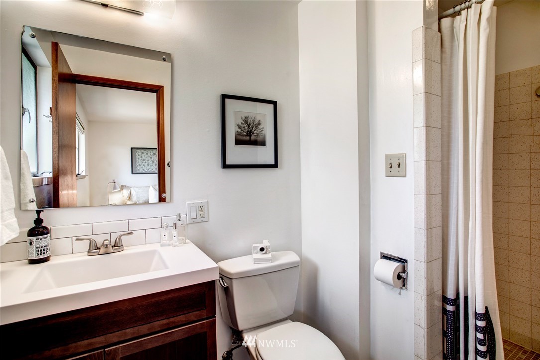 7620 South 115th Street Seattle, WA 98178 - Photo 20 of 33 a bathroom with a sink vanity mirror and toilet