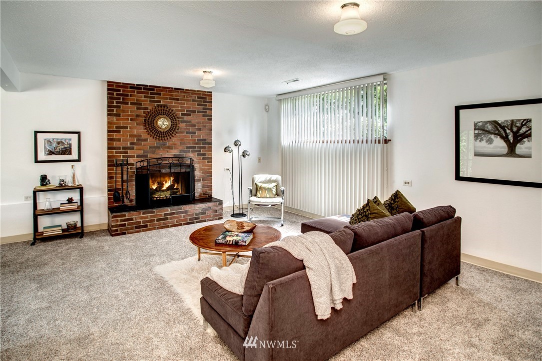 7620 South 115th Street Seattle, WA 98178 - Photo 22 of 33 a living room with furniture and a fireplace
