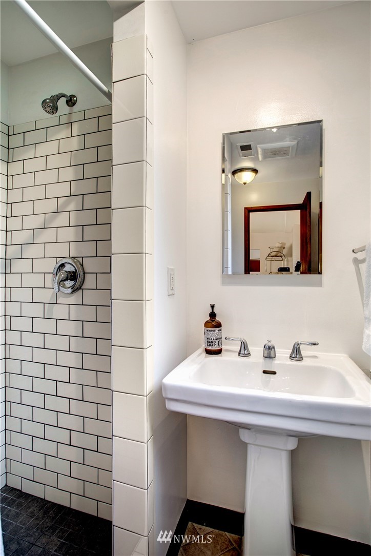 7620 South 115th Street Seattle, WA 98178 - Photo 28 of 33 a bathroom with a sink and a mirror