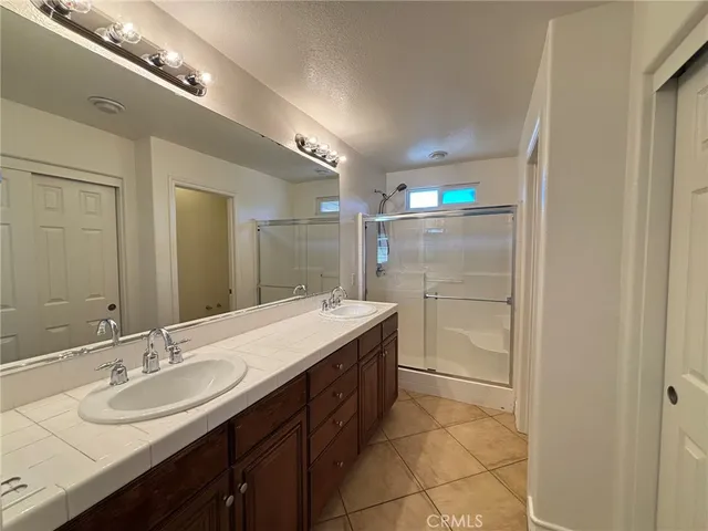 a bathroom with a sink double vanity and a mirror