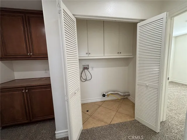 a view of storage and utility room with closet