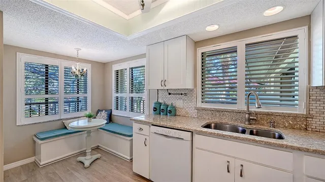 a kitchen with a sink and a large window