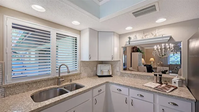 a kitchen with a sink cabinets and window