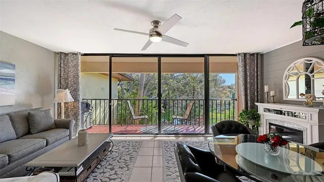 a living room with furniture and a floor to ceiling window