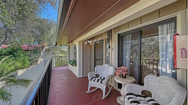 a view of a porch with furniture and wooden floor