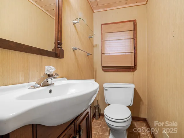 an empty room with a chandelier fan