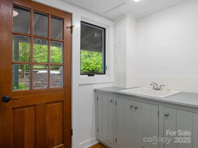 a bathroom with a window and a shower