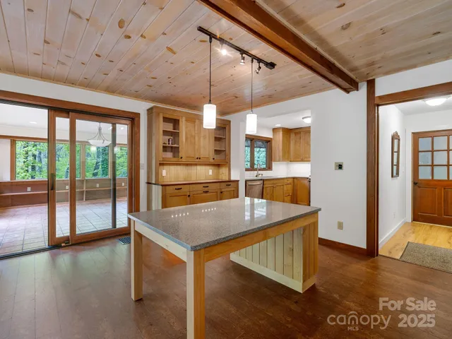 a view of a room with furniture and kitchen view
