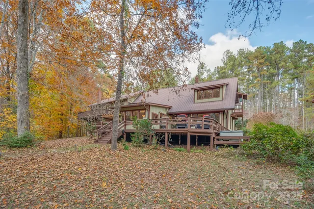 a view of a patio with table and chairs with wooden floor and fence