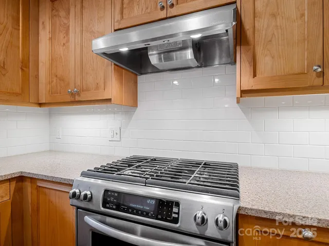 a stove top oven sitting inside of a kitchen