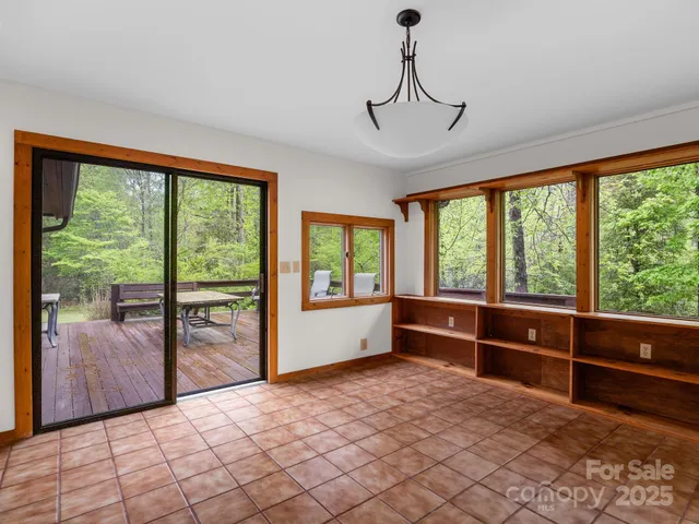 a view of front door with furniture and floor to ceiling window