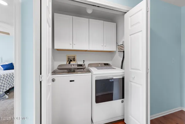 a view of a hallway with wooden floor and entryway
