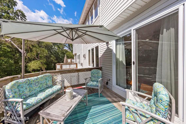 a view of a white house with a big yard and large trees