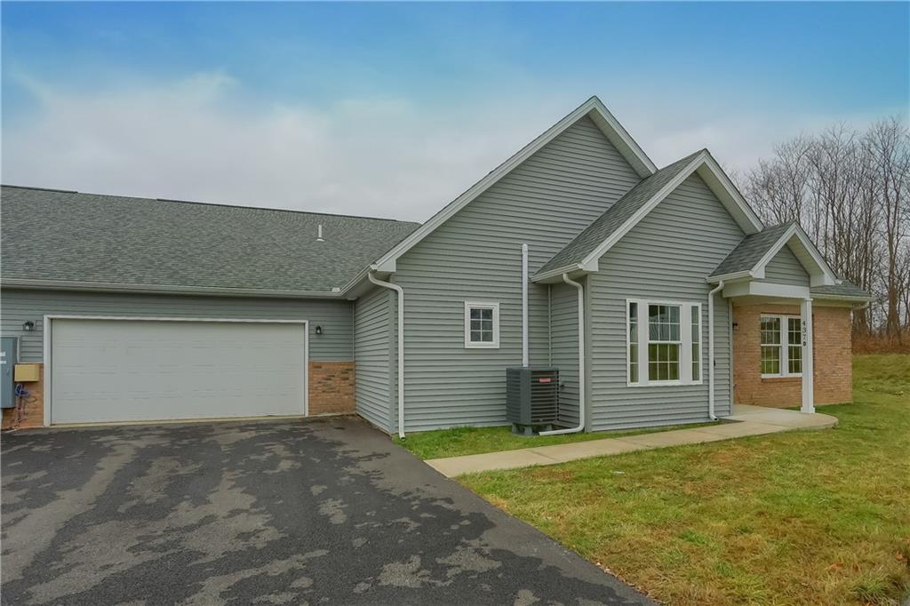 337 Kittery Ridge Drive, Unit D New Castle, PA 16101 - Photo 3 of 25 a view of a house with a yard and garage