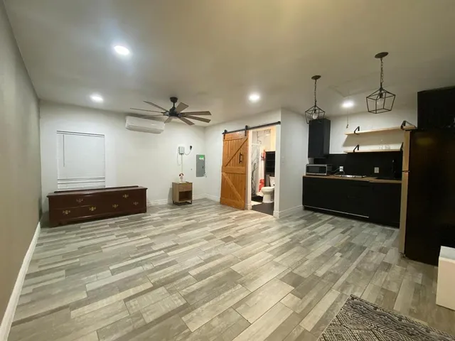 a view of a kitchen with a refrigerator and a sink