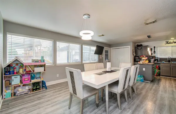 a view of a dining room with furniture window and wooden floor