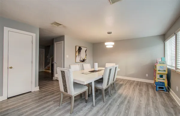 a view of a dining room with furniture and wooden floor