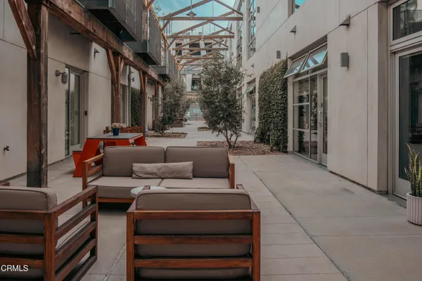 a living room with furniture and a potted plant