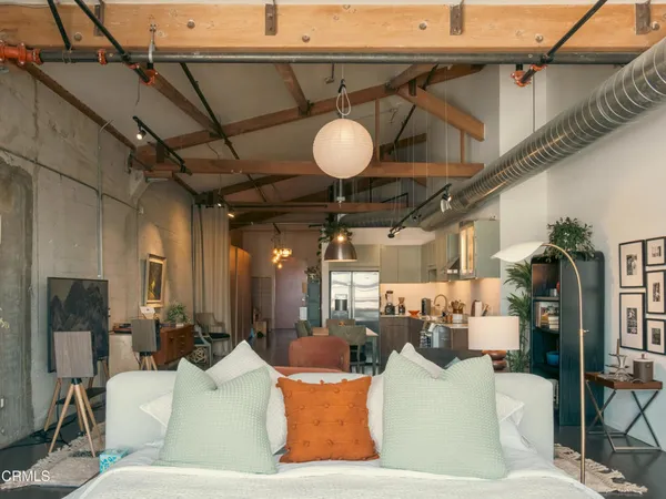 a living room with lots of furniture and a chandelier